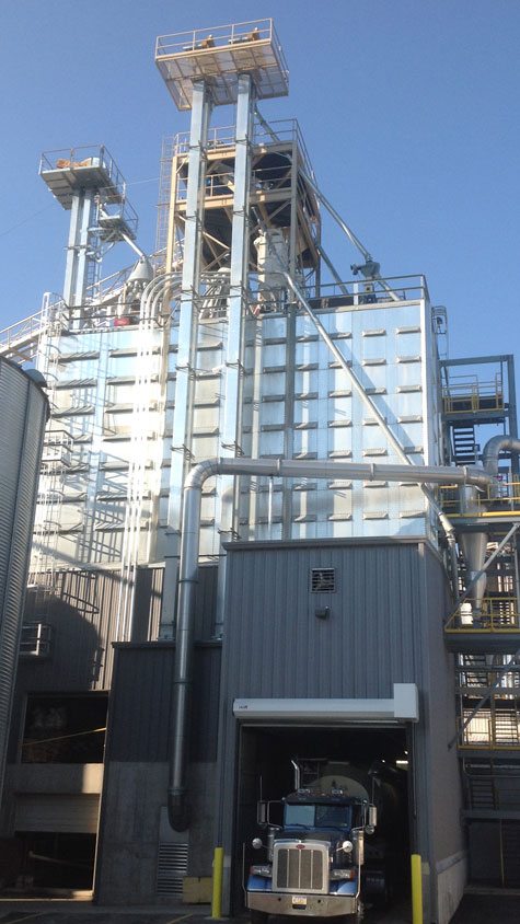 Feed mill tower with a grain truck at the receiving pit